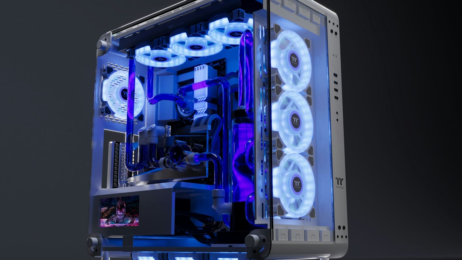 A computer with a liquid cooling loop and radiator fans behind a glass panel