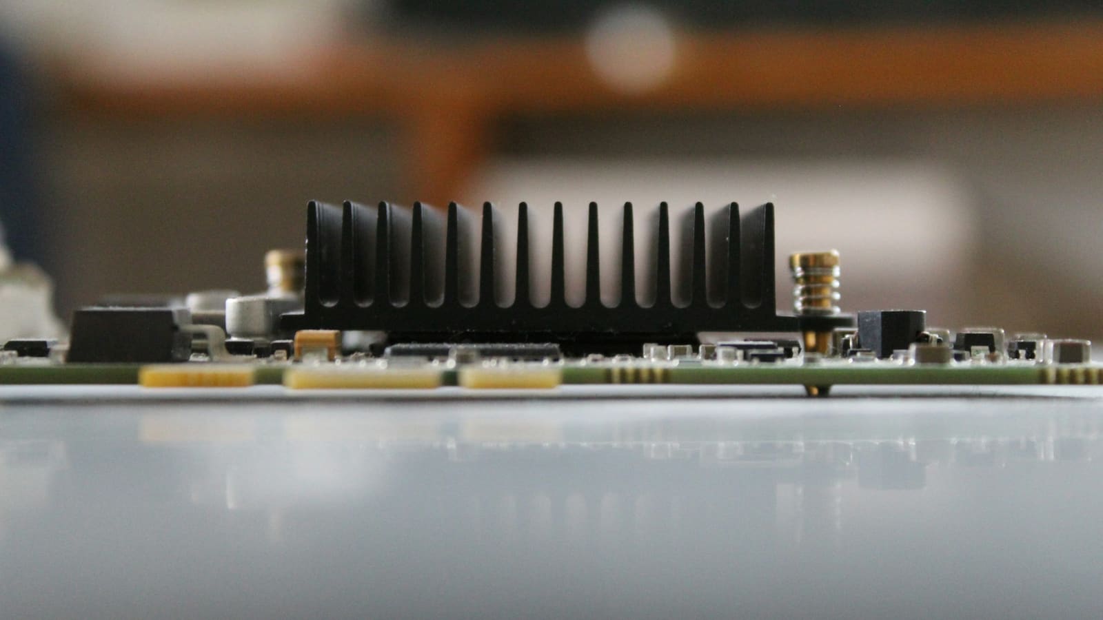 A small low-profile graphics card with a bare finned heatsink