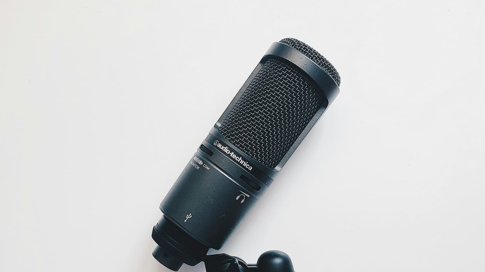 A condenser microphone lying on a plain white surface