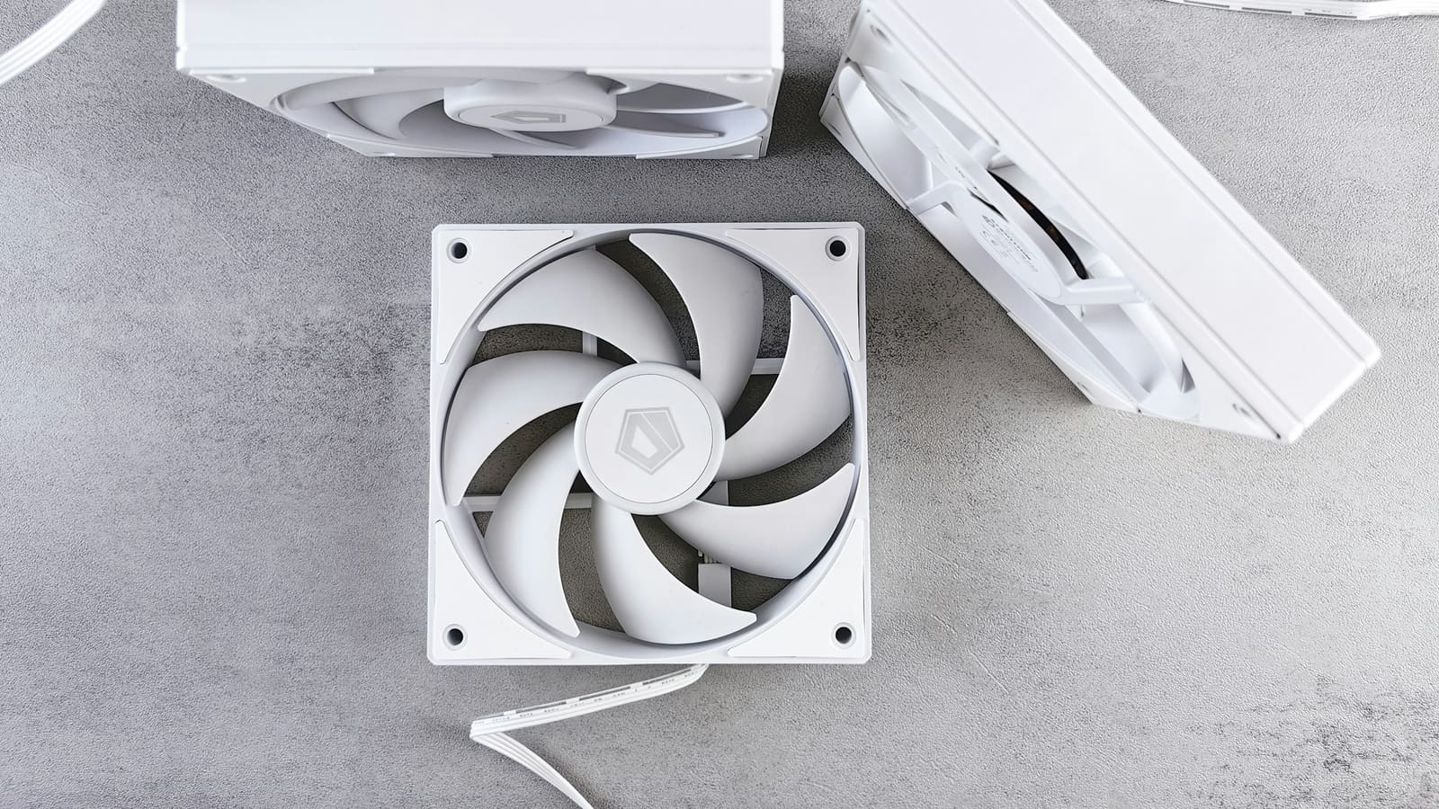 Three case fans arranged on a grey surface