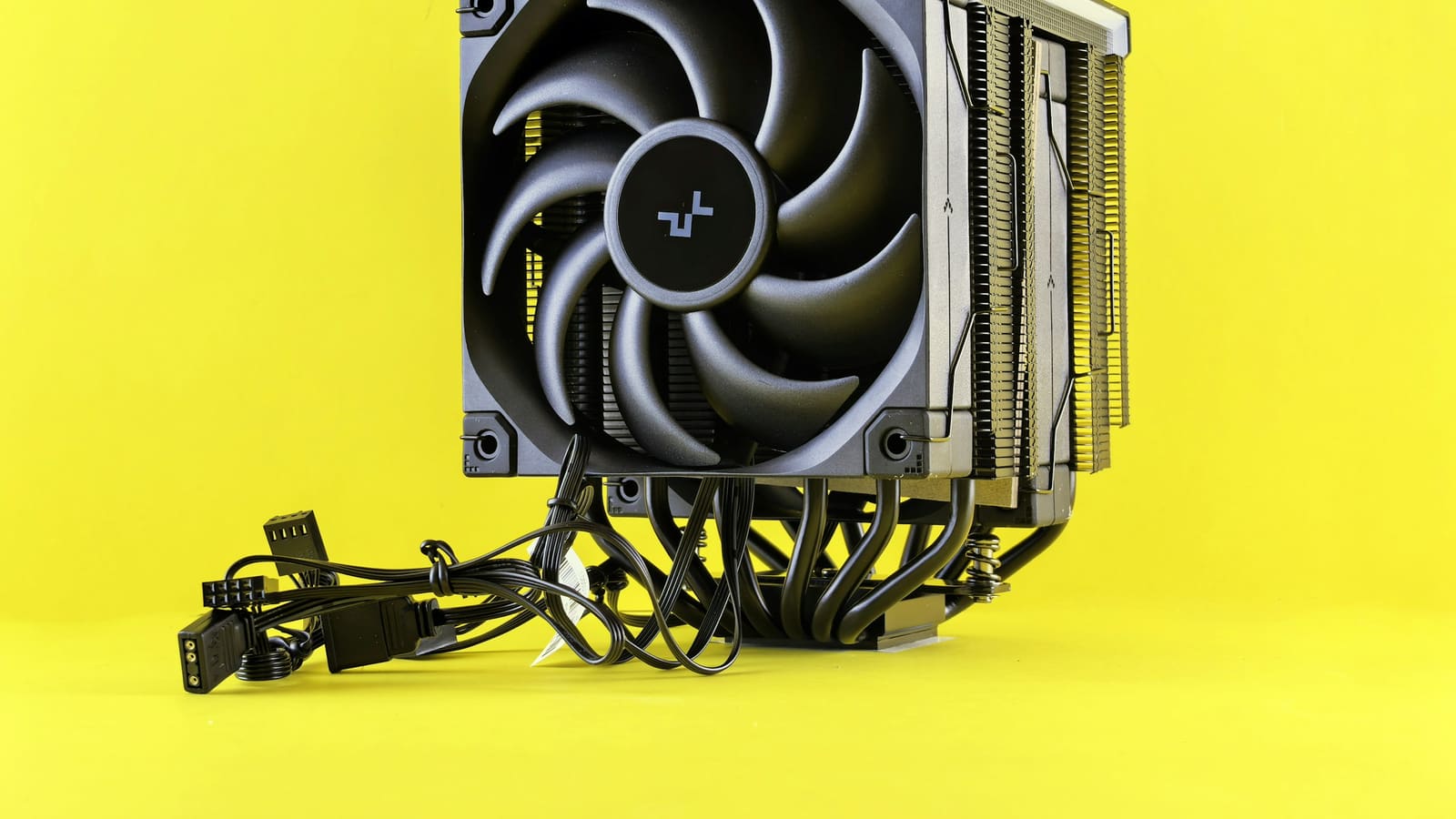 A tower processor cooler with its fan attached, on a plain ground