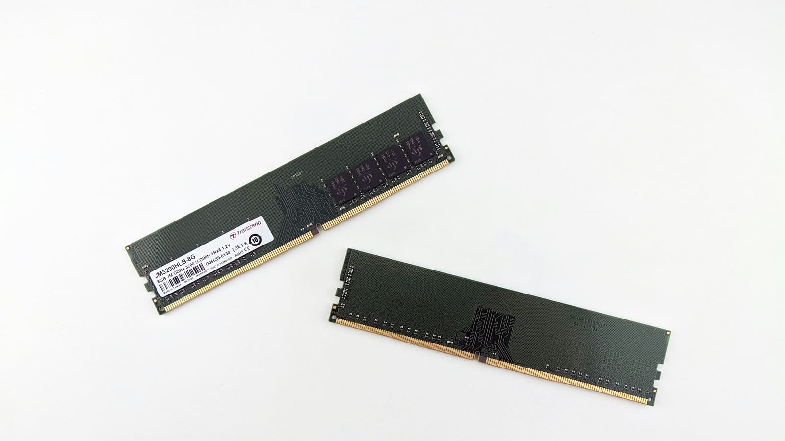 Two memory modules lying on a white surface