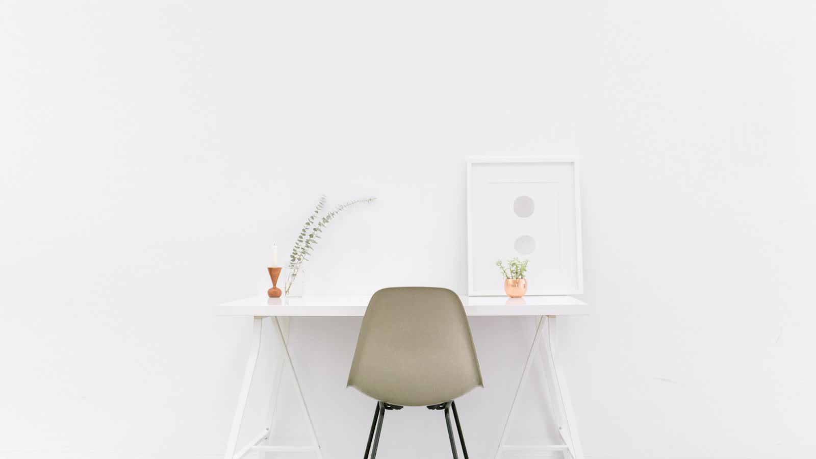 A small desk and chair in a sparsely furnished room