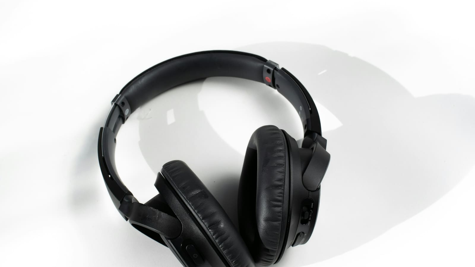 Closed-back studio headphones on a white surface