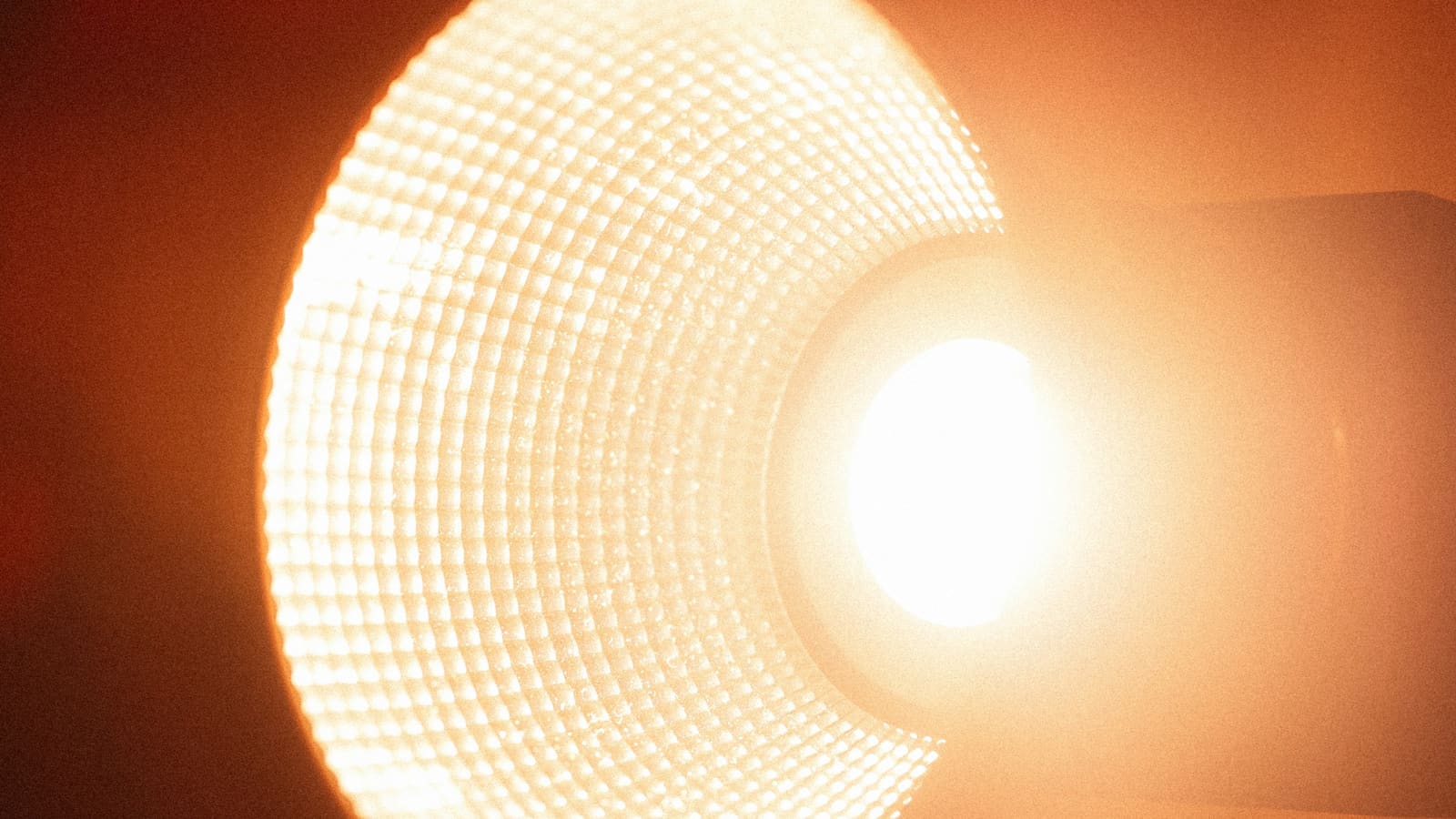 Close-up of a warm light source glowing behind diffusion