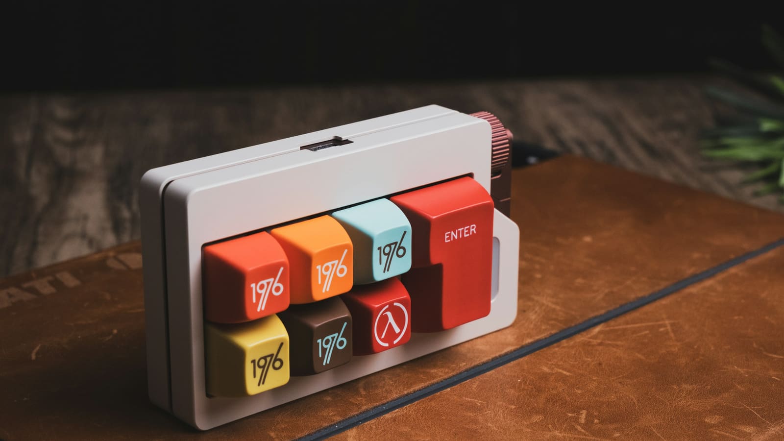 A small programmable keypad with coloured keys on a desk