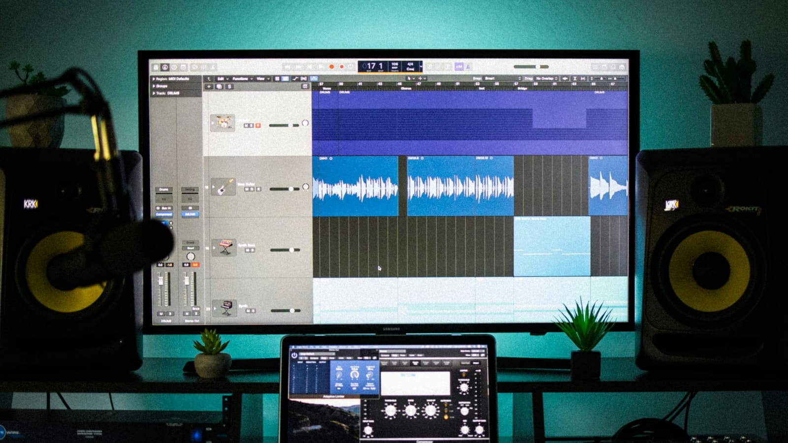 An audio interface on a dim desk beside studio monitors
