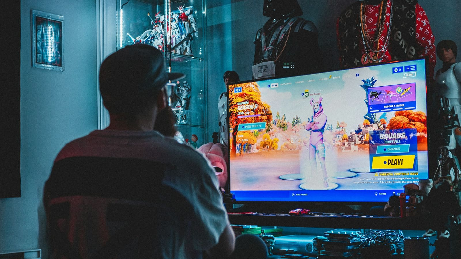 A person playing a game on a television in a dim room
