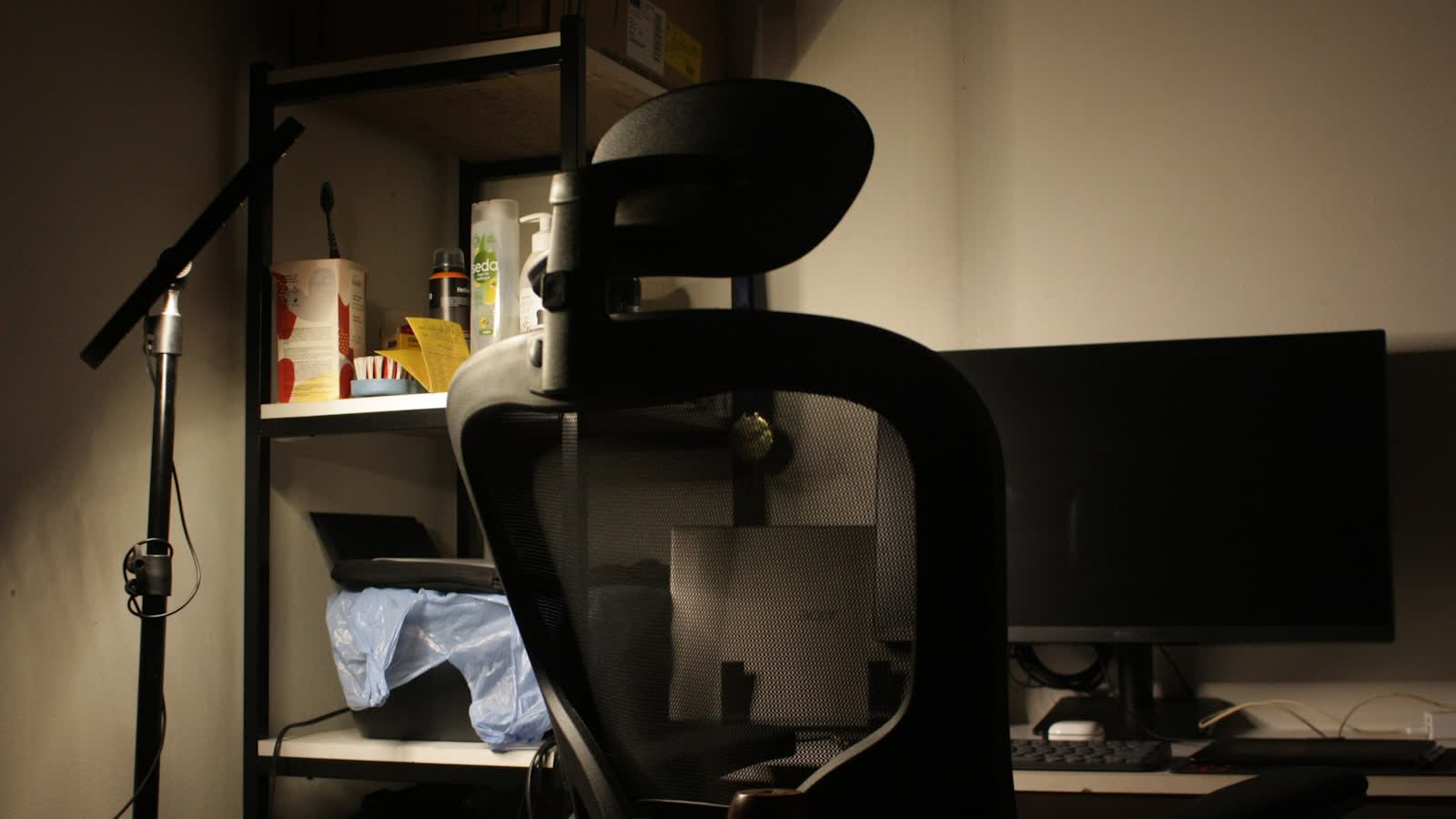 An office chair facing a desk with two monitors