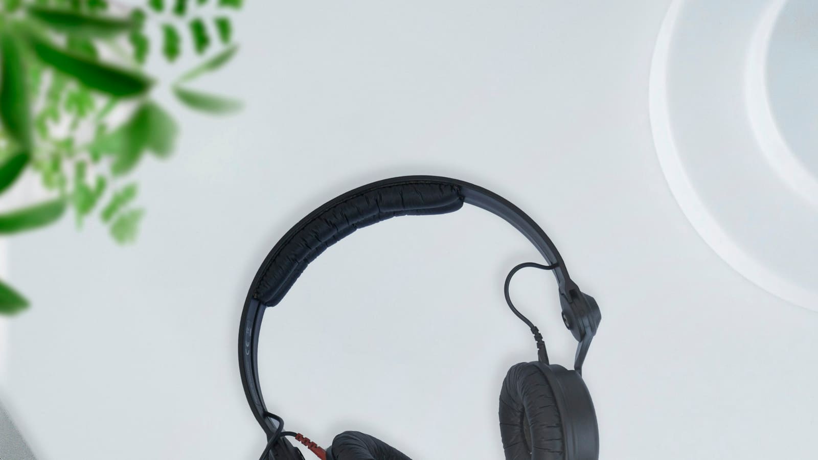 A pair of headphones photographed against a pale background