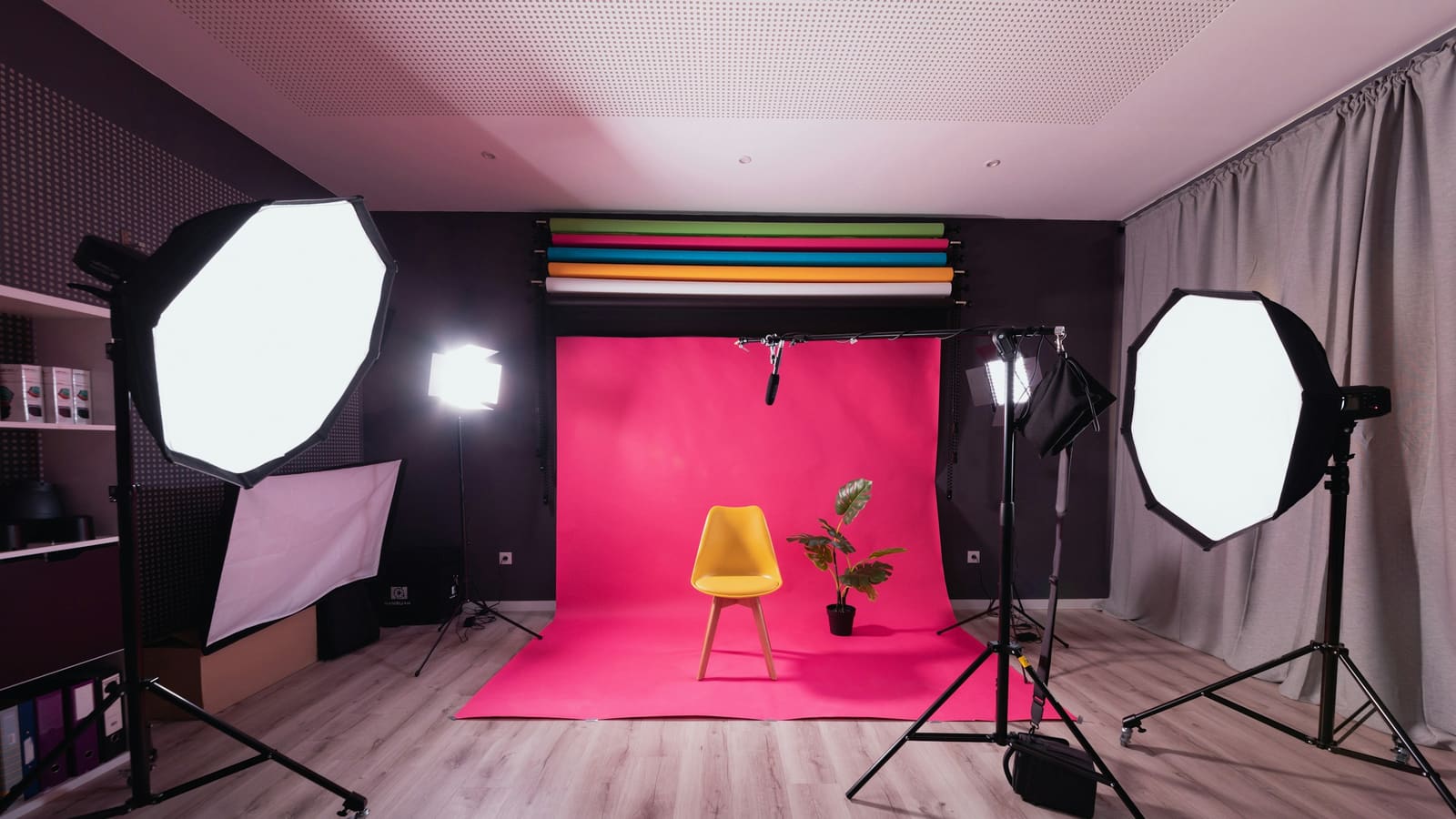 A small studio lit by two softboxes either side of a backdrop